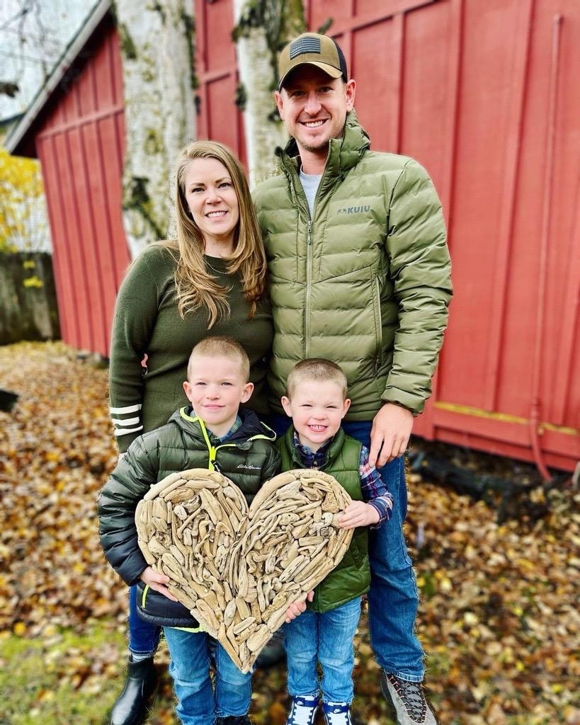 Jenny Kimble with her husband and two sons outdoors in Alaska.